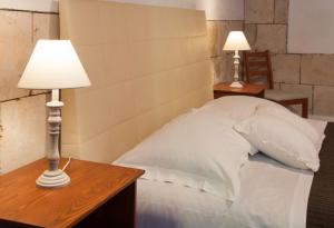 a bedroom with a bed with two tables and a lamp at Bed & Tower in Pisa