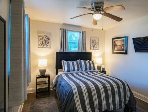 a bedroom with a bed and a ceiling fan at 2bd-2ba Adorable Home w Yard in Gentilly in New Orleans