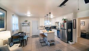 a kitchen with a refrigerator and a table and chairs at 2bd-2ba Adorable Home w Yard in Gentilly in New Orleans
