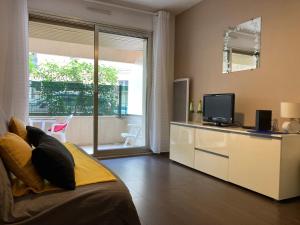 Télévision ou salle de divertissement dans l'établissement Pause Riviera avec terrasse, à 300 mètres de la mer