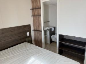 a bedroom with a bed and a desk in a room at Domaine de l' Ile d' or in La Celle-sous-Gouzon