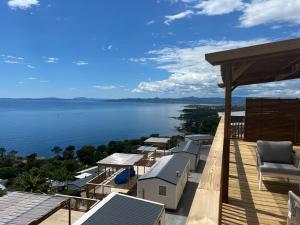 a balcony with a view of the water at Domaine de l' Ile d' or in La Celle-sous-Gouzon +6 photos