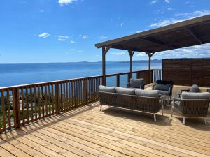 a deck with chairs and a gazebo with the ocean at Domaine de l' Ile d' or in La Celle-sous-Gouzon