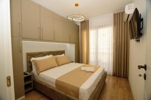 a bedroom with a large bed in a room at Seaside Serenity Apartments - Tirana Resort Radhime in Vlorë