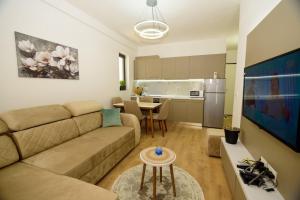 a living room with a couch and a table at Seaside Serenity Apartments - Tirana Resort Radhime in Vlorë