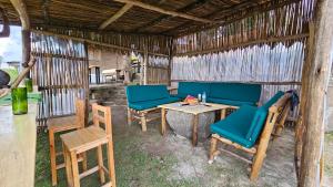 a room with blue chairs and a table and chairs at Twin Lakes Eco Lodge Campsite in Rubirizi