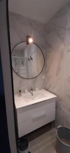 a bathroom with a white sink and a mirror at Chez bigoudy in Penta-di-Casinca +44 photos