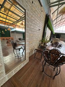 a room with a table and chairs and a mirror at La Casca Experience in Zirakpur