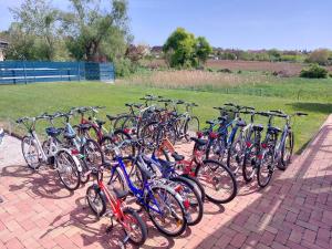 a group of bikes parked in a row on a brick sidewalk at Szárszó Apartmanok in Balatonszárszó