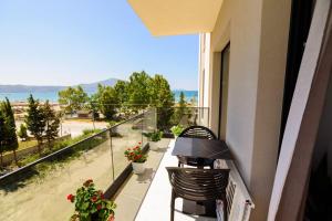 a balcony with chairs and a view of the beach at Seaside Serenity Apartments - Tirana Resort Radhime in Vlorë