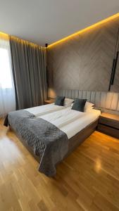 a bedroom with a large bed in a room at DOM Boutique Apartments PARK VIEW in Belgrade