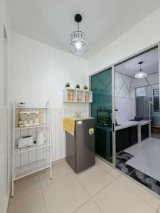 a large kitchen with a counter in a room at Doyar's Home Stay "Palm Garden -Ground Floor" in Lahad Datu