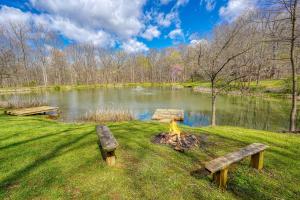two park benches in front of a lake at Wyandot Woods - Cedar House in Laurelville