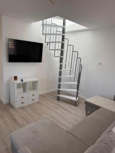 a living room with a spiral staircase in the wall at Ranczo Ryki in Nowy Dwór Gdański