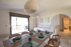 un salon avec une table, des chaises et un canapé dans l'établissement Thani Beach House, Elani by Halkidiki Villas, à Elani