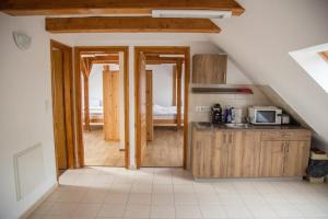 a kitchen with a staircase leading into a room at István lovas tanya in Kiskőrös