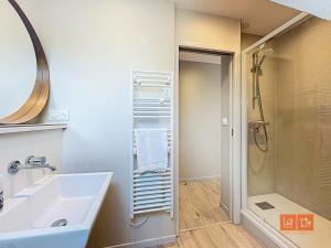a bathroom with a sink and a shower at Le studio in Ambleteuse