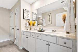 a bathroom with two sinks and two mirrors at Price Cut, New Lux Home 5 mins to Airport , 15 min to Downtown, 25 min to Buckhead with 3 beds and 3 baths in Atlanta