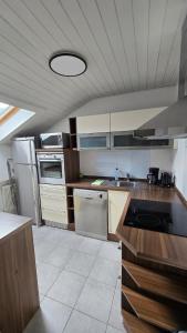 a kitchen with white appliances and a ceiling at Hike, Bike & More in Parcines