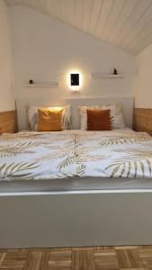 a white bed with pillows on top of it at Hike, Bike & More in Parcines