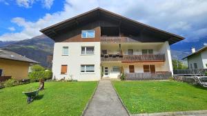 a large house with a green lawn in front of it at Hike, Bike & More in Parcines