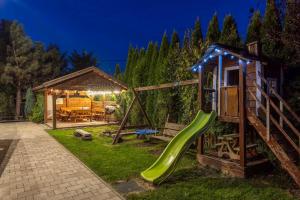 a playground with a slide and a house at Rodzinny zakątek - Noclegi w Bieszczadach - jacuzzi in Myczkowce