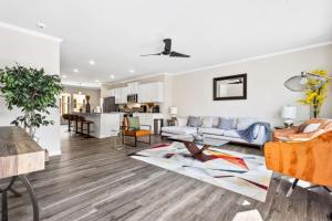 a living room with a couch and a table at Price Cut, New Lux Home 5 mins to Airport , 15 min to Downtown, 25 min to Buckhead with 3 beds and 3 baths in Atlanta +28 photos