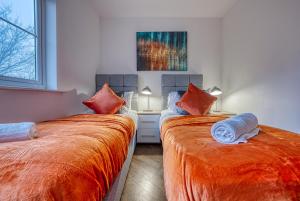 two beds sitting next to each other in a room at Peaceful 2-Bed in Sutton Coldfield, Near Parks in Sutton Coldfield