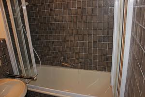 a bathroom with a tub and a toilet and a sink at Ferienwohnung Samerhof Christ in Aschau im Chiemgau
