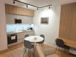 a kitchen with a table and chairs in a room at modern apartment in Senica
