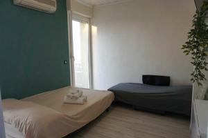 a room with two beds and a window at Central View Loft in Lignano Sabbiadoro