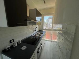 a kitchen with a sink and a counter top at Central View Loft in Lignano Sabbiadoro