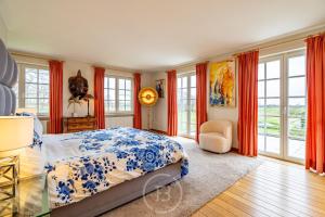 a bedroom with a bed with a blue and white bedspread at Blauw aan zee in De Panne +48 photos
