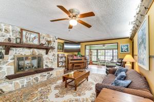 a living room with a couch and a fireplace at Lakefront Apt with Canoes in Inverness! in Inverness