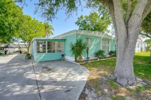 a tiny house in a park with a tree at Boat and Fish Canal-Front Home on River in Okeechobee