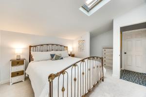 a white bedroom with a bed and a white door at 1 Mi to Attractions Getaway with Mtn Views! in Colorado Springs