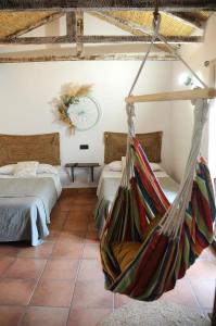 a room with two beds and a hammock at Casa Rural El Gallo in Casas de Haro