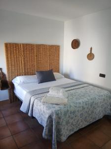 a bedroom with a bed with a blue pillow at Casa Rural El Gallo in Casas de Haro +32 photos