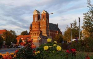 a castle building with flowers in front of it at Wohnung mit Galerie in Prenzlau