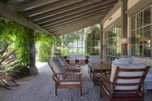 a porch with chairs and a table and windows at Villa Askizu by FeelFree Rentals in Getaria +26 photos