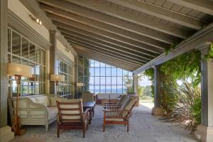 a porch with chairs and a table and a couch at Villa Askizu by FeelFree Rentals in Getaria