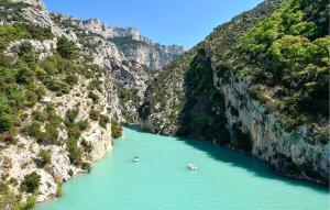 two boats in a river in a canyon at Lovely Home In Moustiers-Sainte-Marie in Moustiers-Sainte-Marie +8 photos