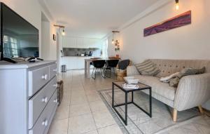 a living room with a couch and a table at Amazing Home In Saint Pons La Calm in Saint-Pons-la-Calm