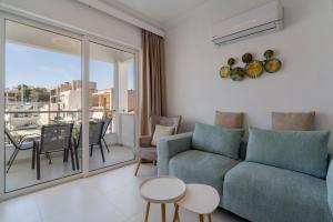 a living room with a couch and a table at Howard Luxury APT in Agios Nikolaos
