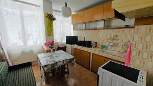 a kitchen with a sink and a table in it at Апартамент Димови in Tryavna