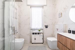 a white bathroom with a toilet and a sink at Casa Blue Moon in Baveno +23 photos