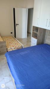 a bedroom with a blue bed and a closet at Il Risveglio delle Onde 2 in Torre Ovo +5 photos