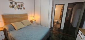 a small bedroom with a bed and a mirror at Casa amplia en Costanera in Posadas