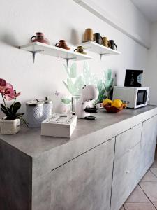 a kitchen with a counter top with a microwave at Summer House in SantʼAntìoco