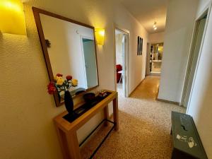 a room with a mirror and a vase with flowers on a table at Hermoso piso en la playa in Miramar +129 photos